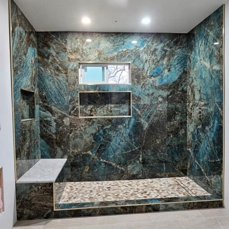 Blue marble shower with built-in shelves and modern bathroom design.