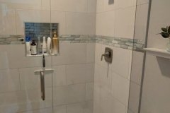 Contemporary bathroom shower featuring glass doors, tiled walls, and modern fixtures for a sleek look.