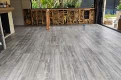 Quality gray tile flooring being installed in a residential or commercial setting.