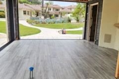 Beautifully tiled open living space with a view of the garden, emphasizing quality tile work for homes.