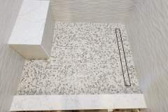 Elegant terrazzo tile flooring featuring a decorative inlay, ideal for contemporary residential and commercial spaces.