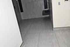 Image of a clean, modern interior with gray tile flooring and minimalist wall accents.