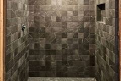 Elegant gray tiled shower with built-in niche, perfect for modern bathrooms.