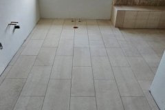 Interior view showcasing new tile flooring and wall design by Grapme Tile Works Corp.