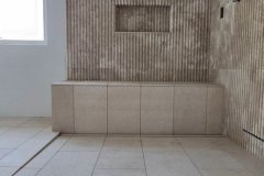 Interior wall with textured tiles and niche, showcasing quality tile installation by GRAPME TILE WORKS CORP.