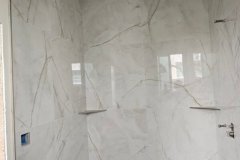 Modern bathroom with marble wall tiles installed by Grapme Tile Works, showcasing quality craftsmanship and stylish design.