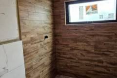 Up of a bathroom with stylish wooden tiles on the wall, showcasing modern design and high-quality craftsmanship.