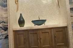 Custom tile installation in a stylish bathroom with a curved wall and modern fixtures.