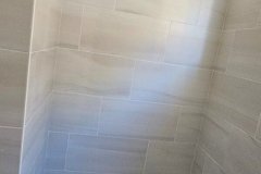 Professional bathroom wall tiling by Grapme Tile Works Corp, emphasizing quality and craftsmanship.