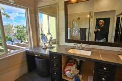 Luxurious bathroom with stylish vanity, marble countertop, and elegant lighting.