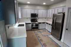 Spacious kitchen featuring white cabinetry, stainless steel appliances, and ample counter space for cooking and storage.