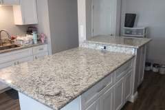 Modern kitchen featuring a polished granite countertop, perfect for cooking and entertaining.