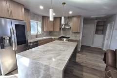 A contemporary kitchen showcasing granite countertops, stainless steel appliances, and wooden cabinets for a stylish look.