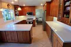 A bright, modern kitchen featuring wooden cabinets, a large island, and ample counter space.