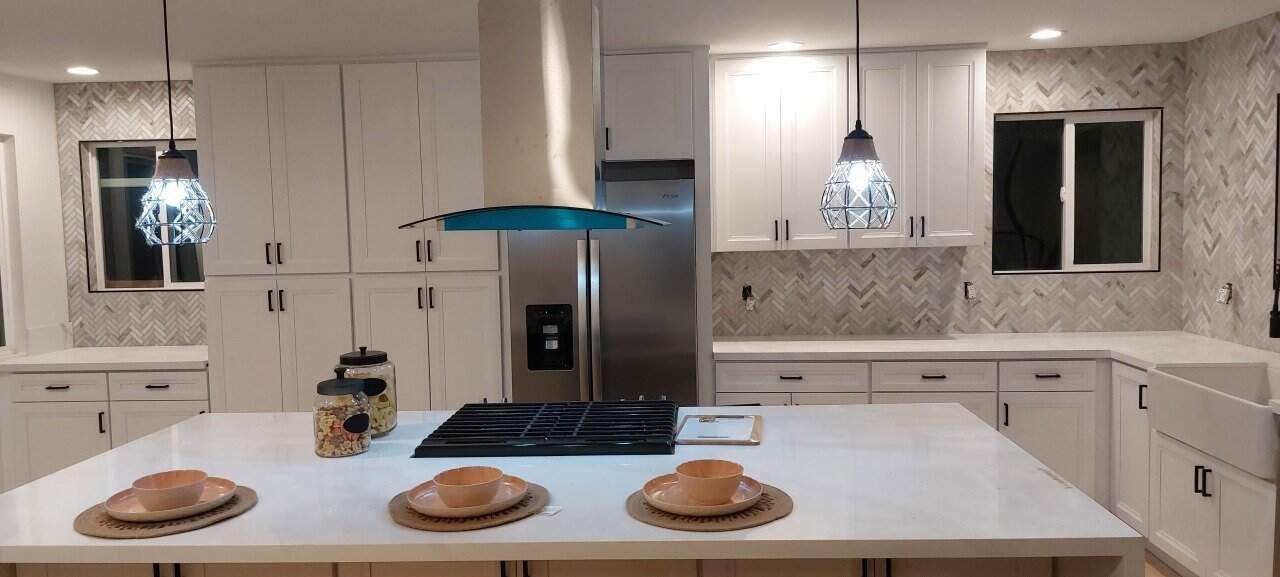 Modern kitchen featuring tile backsplash and central island.